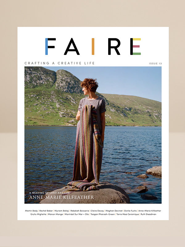 Magazine cover titled 'FAIRE' with a person in a long dress standing by a lake.