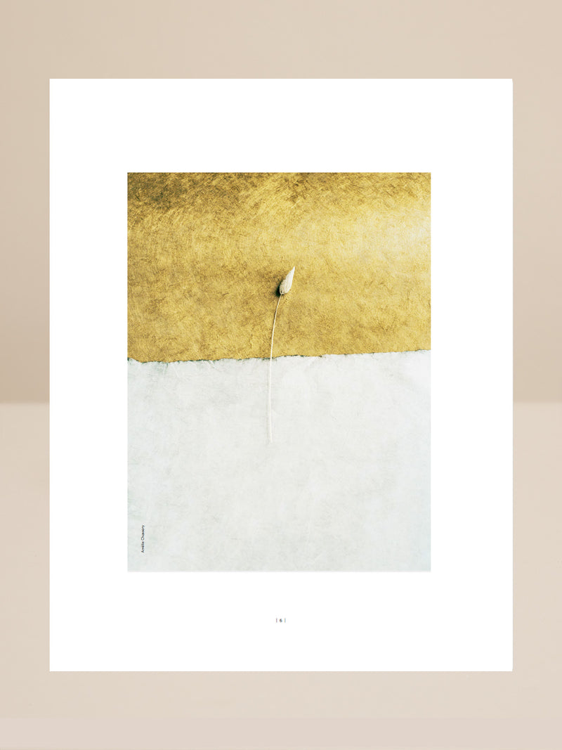 Abstract art piece with gold and white sections on a beige background