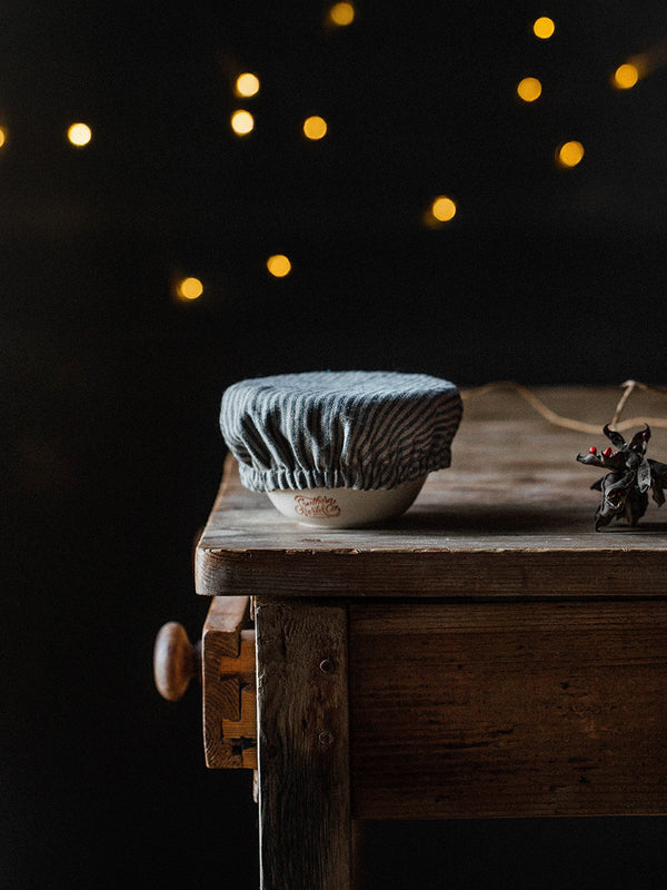Southern Wild Co Bendigo Pottery candle on a vintage table with fairy lights