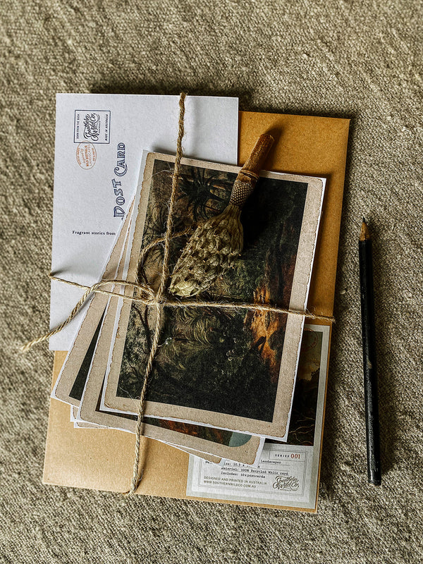 Set of vintage-style photographs and envelopes tied with twine on a textured surface