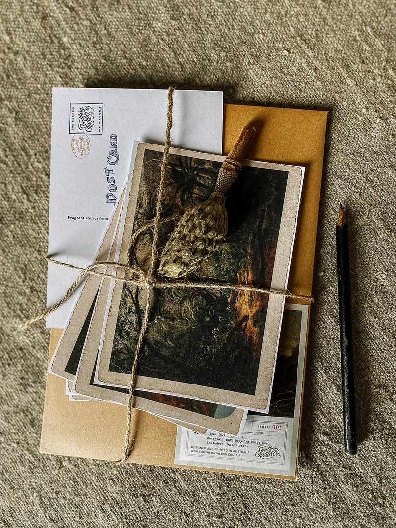Set of vintage-style photographs and envelopes tied with twine on a textured surface
