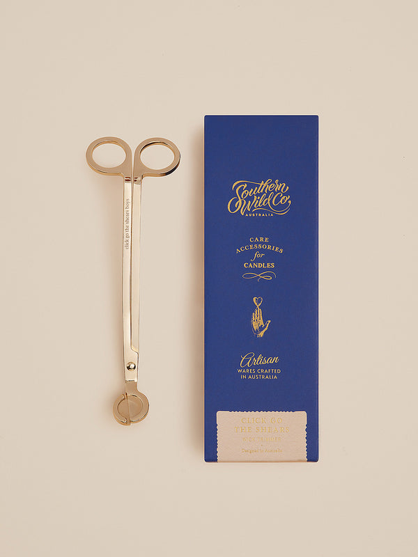 Click Go the Shears gold wick trimmer beside its deep blue Southern Wild Co box — a nostalgic nod to Australiana, crafted for trimming wicks in timeless style.