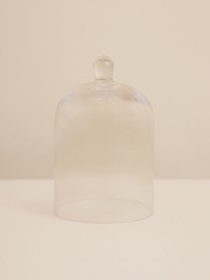 Handblown clear glass cloche with rounded knob, designed to preserve scent and protect your candle with quiet beauty.