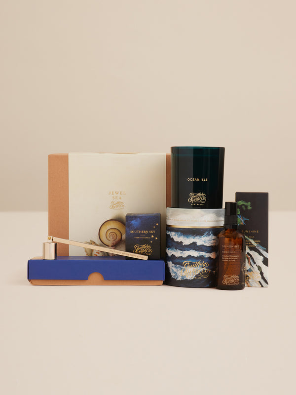 Jewel Sea gift set by Southern Wild Co featuring Ocean Isle candle, Sunshine room mist, Southern Sky votive, and candle tools evoking the scents and spirit of the sea.