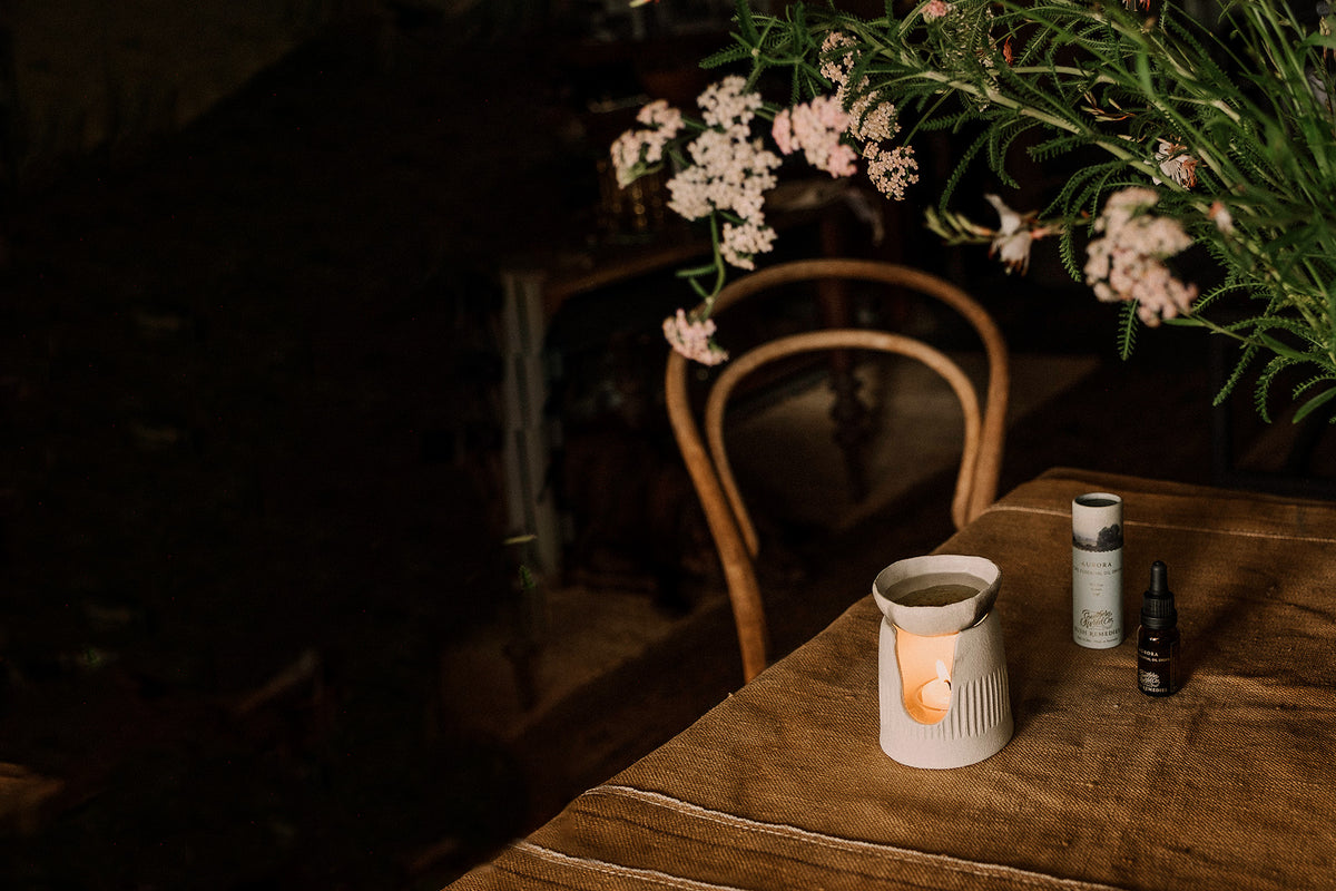 Candlelit table setting with flowers and candles in a cozy indoor setting