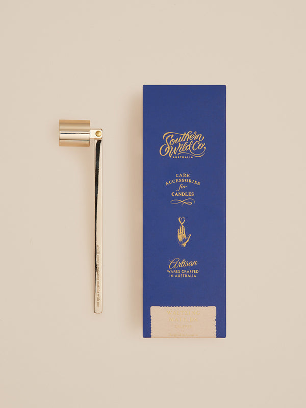 Southern Wild Co’s Waltzing Matilda candle snuffer beside its blue gift box — a golden homage to ritual and song, made for candle lovers.