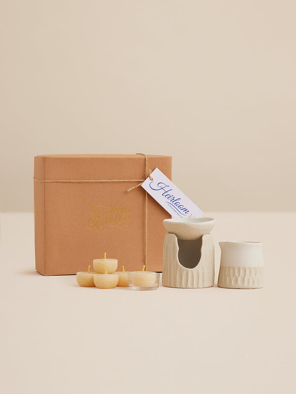 Handcrafted clay oil burner set with beehive texture, beeswax tealights, and pourer, presented in a kraft gift box by Southern Wild Co and Clay Beehive.