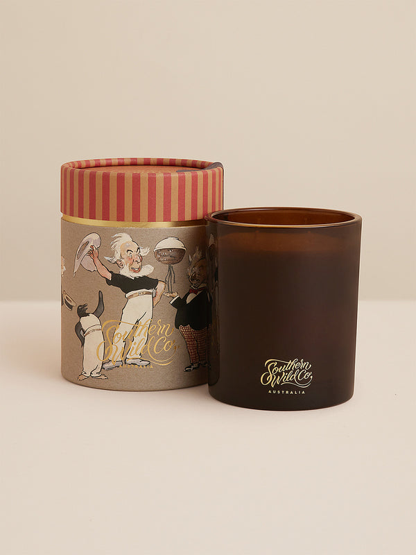 Magic Pudding scented candle in amber glass with illustrated gift box featuring Norman Lindsay’s whimsical bush characters — a playful Australian candle with notes of red mandarin, cardamom and clove.