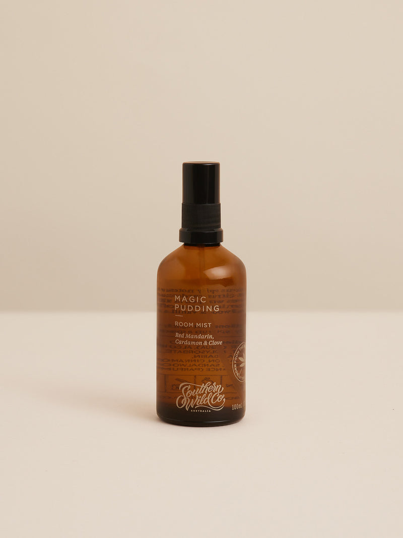 Magic Pudding room mist in amber glass bottle — a spirited blend of red mandarin, cardamom and clove, evoking festive bush gatherings and warm Australian summers.