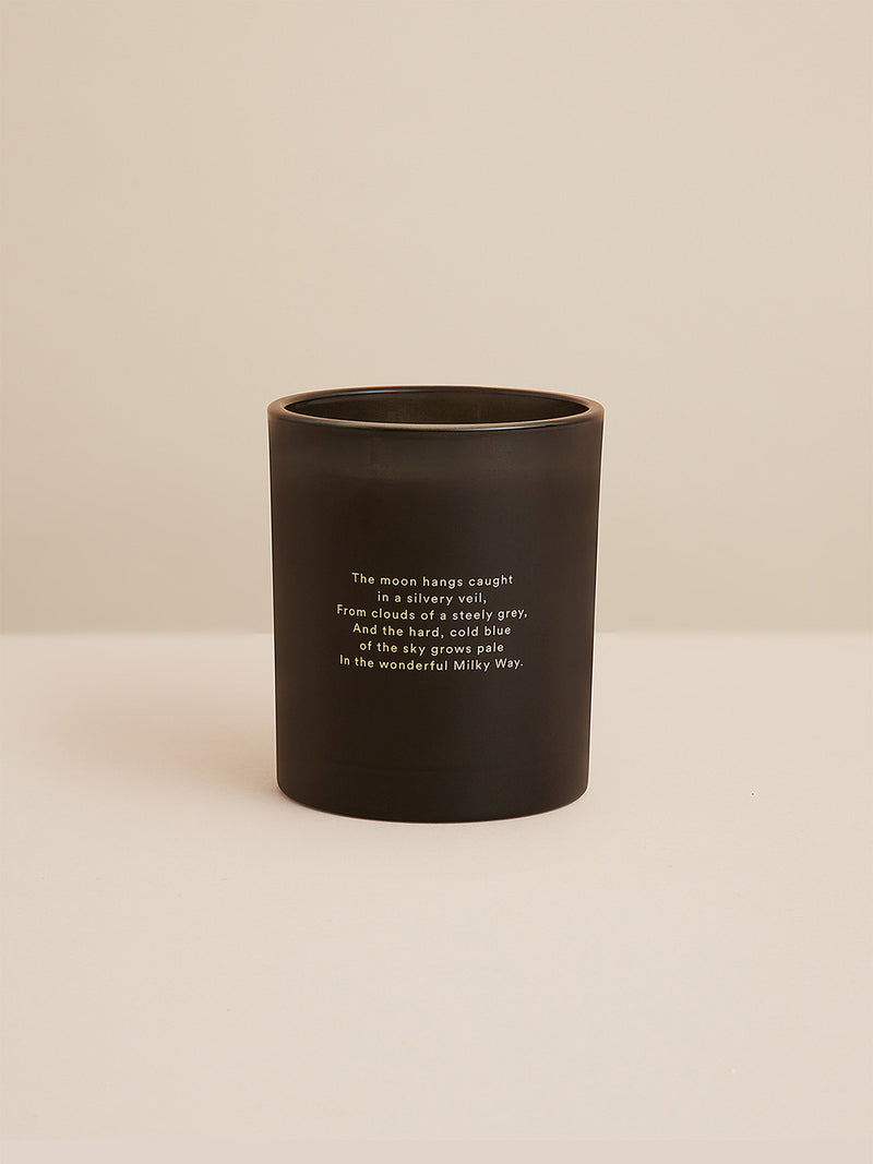 Studio shot of the unlit Southern Sky candle in matte black glass, etched with a celestial verse by poet Henry Lawson—simple, poetic, and designed to echo the quiet of the night sky.