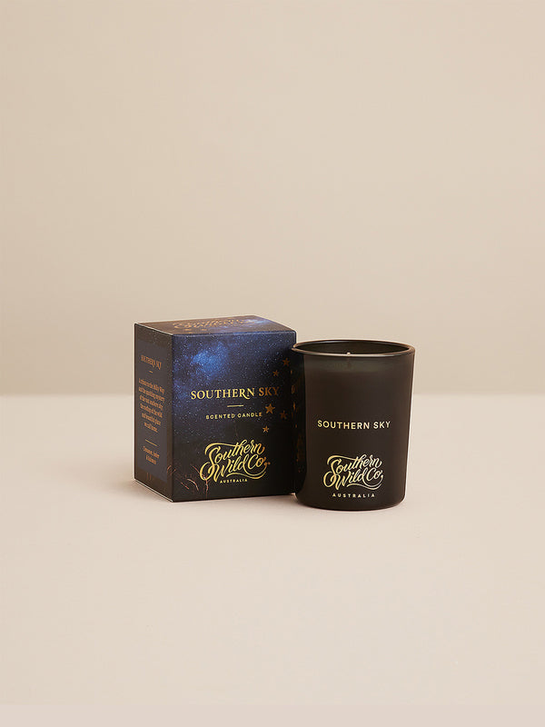 Studio image of Southern Sky candle and box, featuring gold foil details and deep indigo tones—luxury Australian candle inspired by the constellations above.